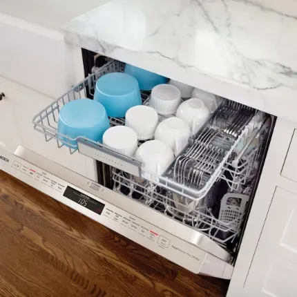 Opened dishwasher with clean dishes
